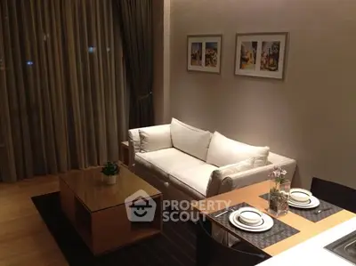 Cozy living room with elegant decor and dining area in modern apartment.