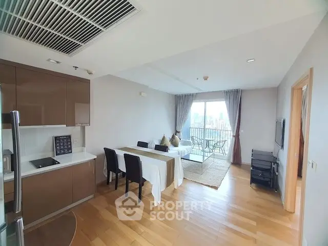 Modern open-plan living room with dining area and city view balcony