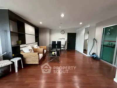 Spacious living room with modern decor and wooden flooring