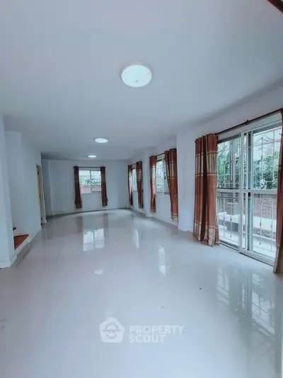 Spacious living room with large windows and natural light