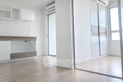 Modern minimalist apartment interior with sleek wooden flooring and built-in storage solutions.