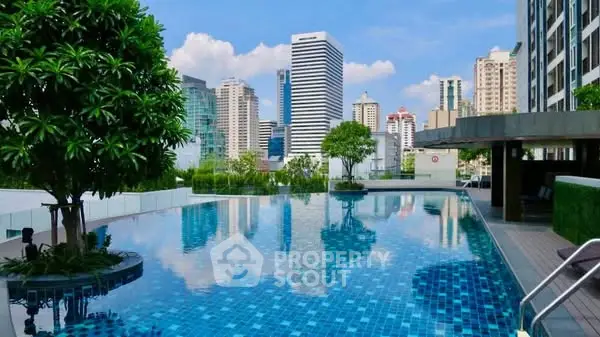 Luxurious rooftop pool with stunning city skyline views in a modern urban setting.