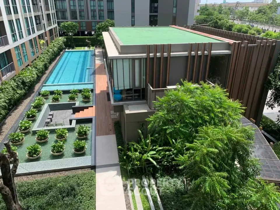 Luxurious condo with stunning pool and lush garden view
