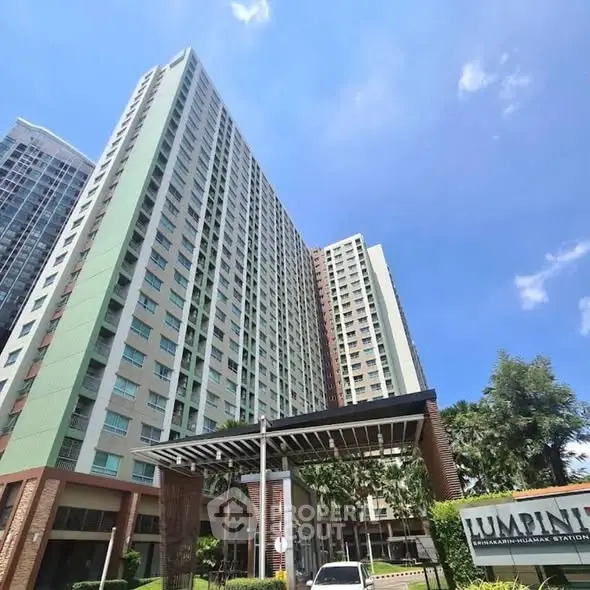 Stunning high-rise residential building with modern architecture and lush surroundings.