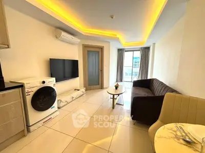 Modern living room with stylish furniture and built-in appliances, featuring a washing machine and sleek decor.