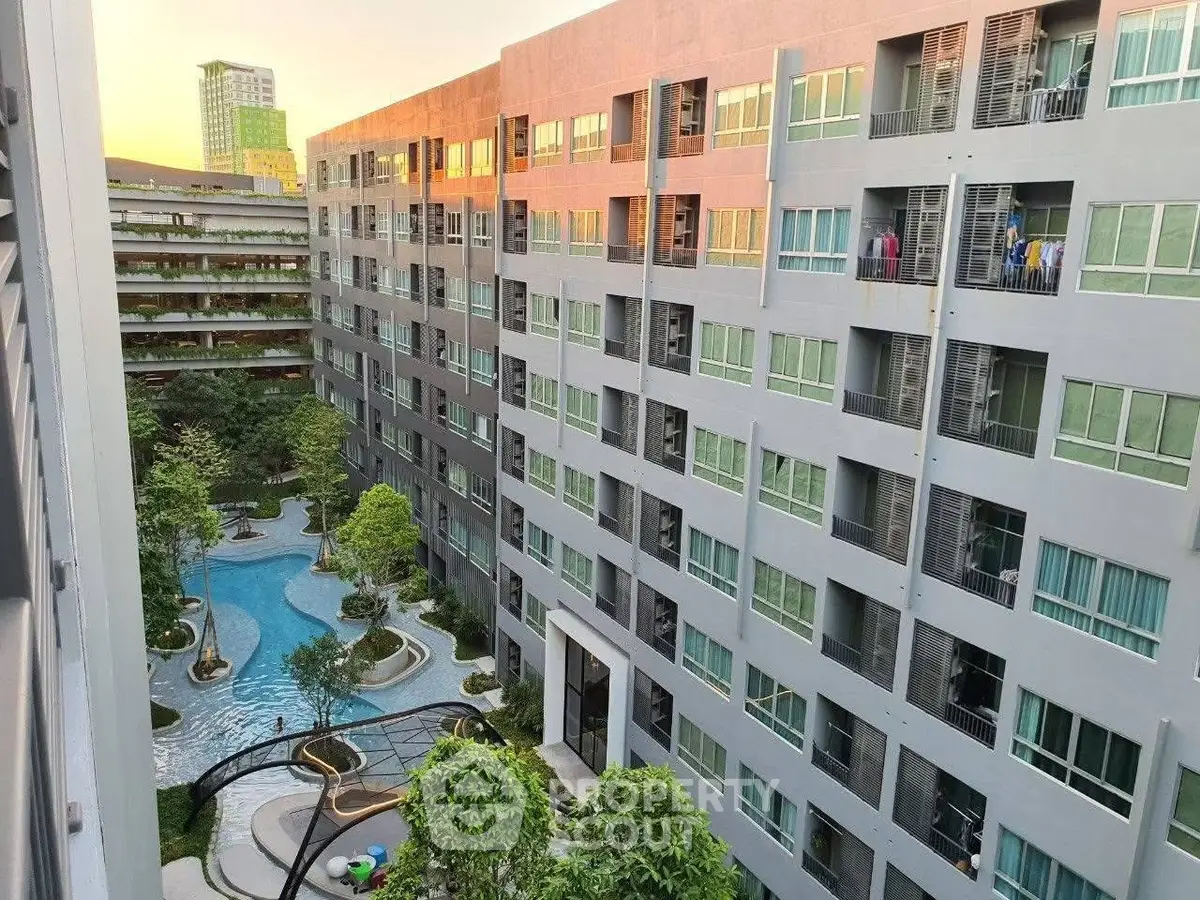 Modern apartment complex with pool and landscaped garden view