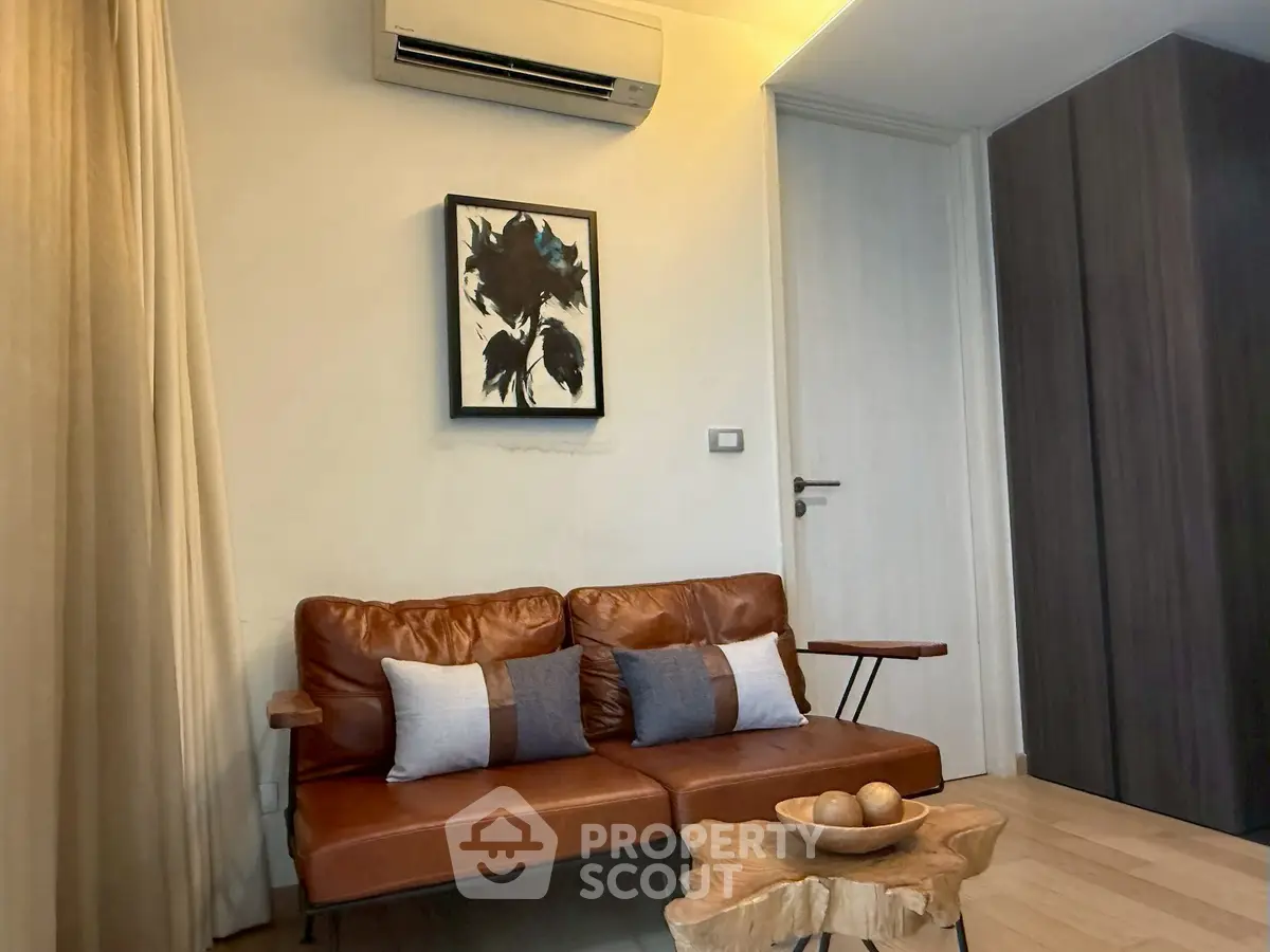 Cozy living room with leather sofa, modern art, and wooden accents