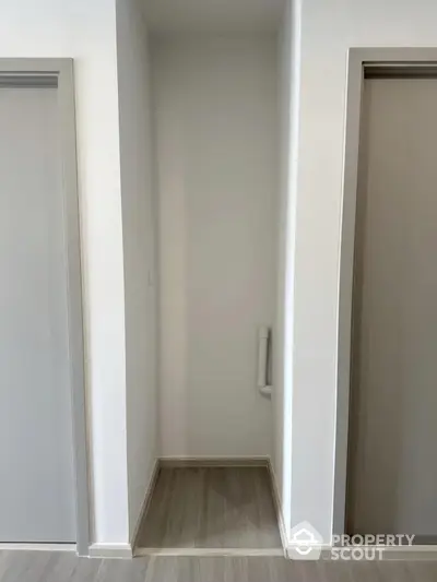 Minimalist hallway with modern doors and sleek flooring