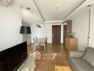 Spacious modern living room with elegant dining area and stylish furnishings.