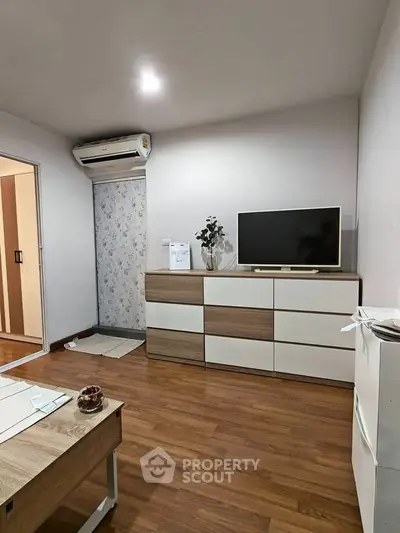 Modern living room with wooden flooring and sleek furniture design