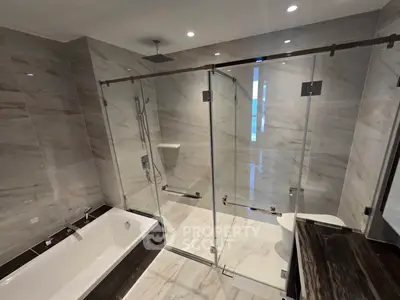 Luxurious modern bathroom with glass shower and bathtub