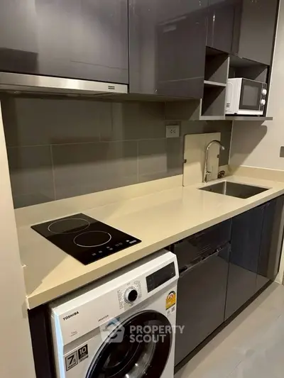 Modern kitchen with sleek appliances and compact design
