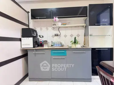 Compact kitchen with modern cabinetry and appliances, ideal for efficient cooking in small spaces.