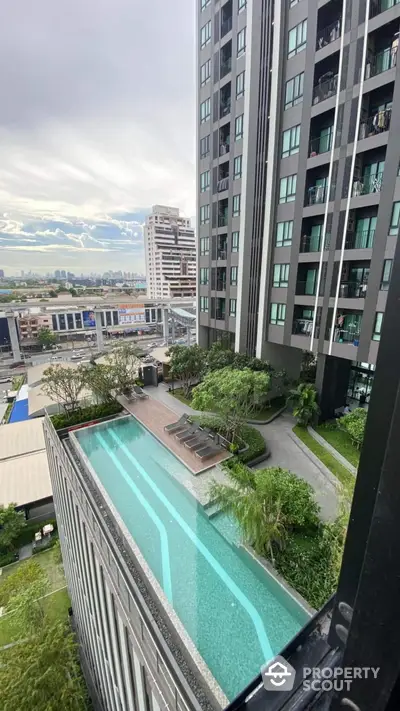 Modern high-rise building with rooftop pool and city view