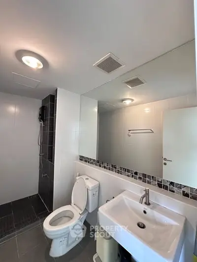 Modern bathroom with sleek fixtures and spacious shower area