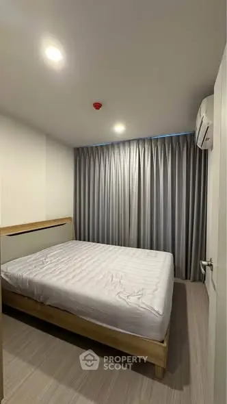 Cozy bedroom with modern decor and ample natural light