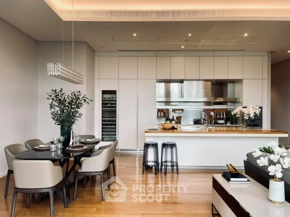 Luxurious modern kitchen with dining area, sleek cabinetry, and elegant lighting.