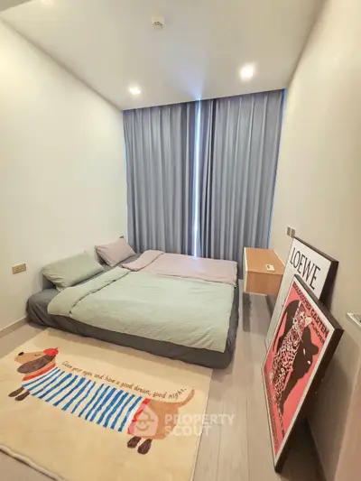 Cozy bedroom with modern decor and stylish rug, featuring a comfortable bed and elegant curtains.