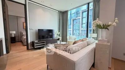 Luxurious modern living room with large windows and elegant decor in a high-rise apartment.