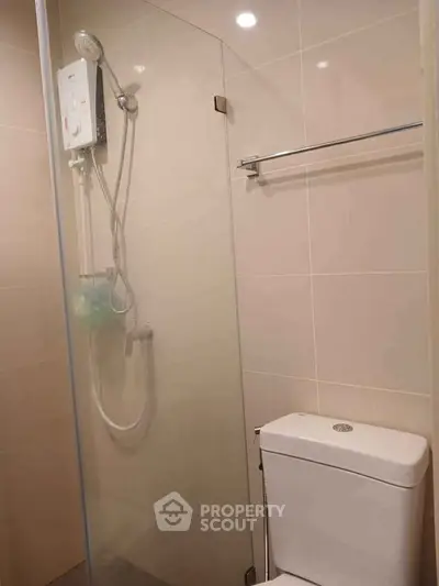 Modern bathroom with glass shower enclosure and sleek fixtures