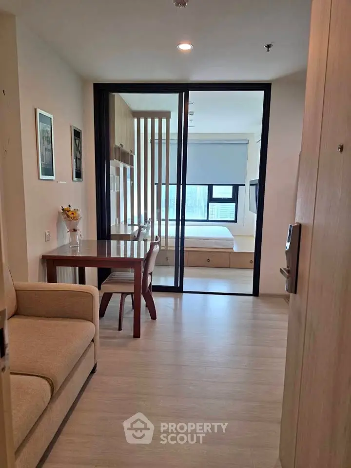 Modern studio apartment with open layout and stylish furnishings, featuring a cozy living area and a bright bedroom.
