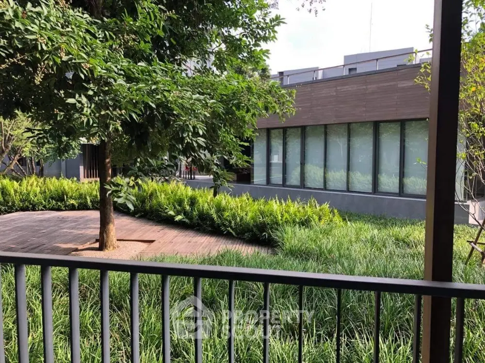 Modern building with lush garden view and wooden deck