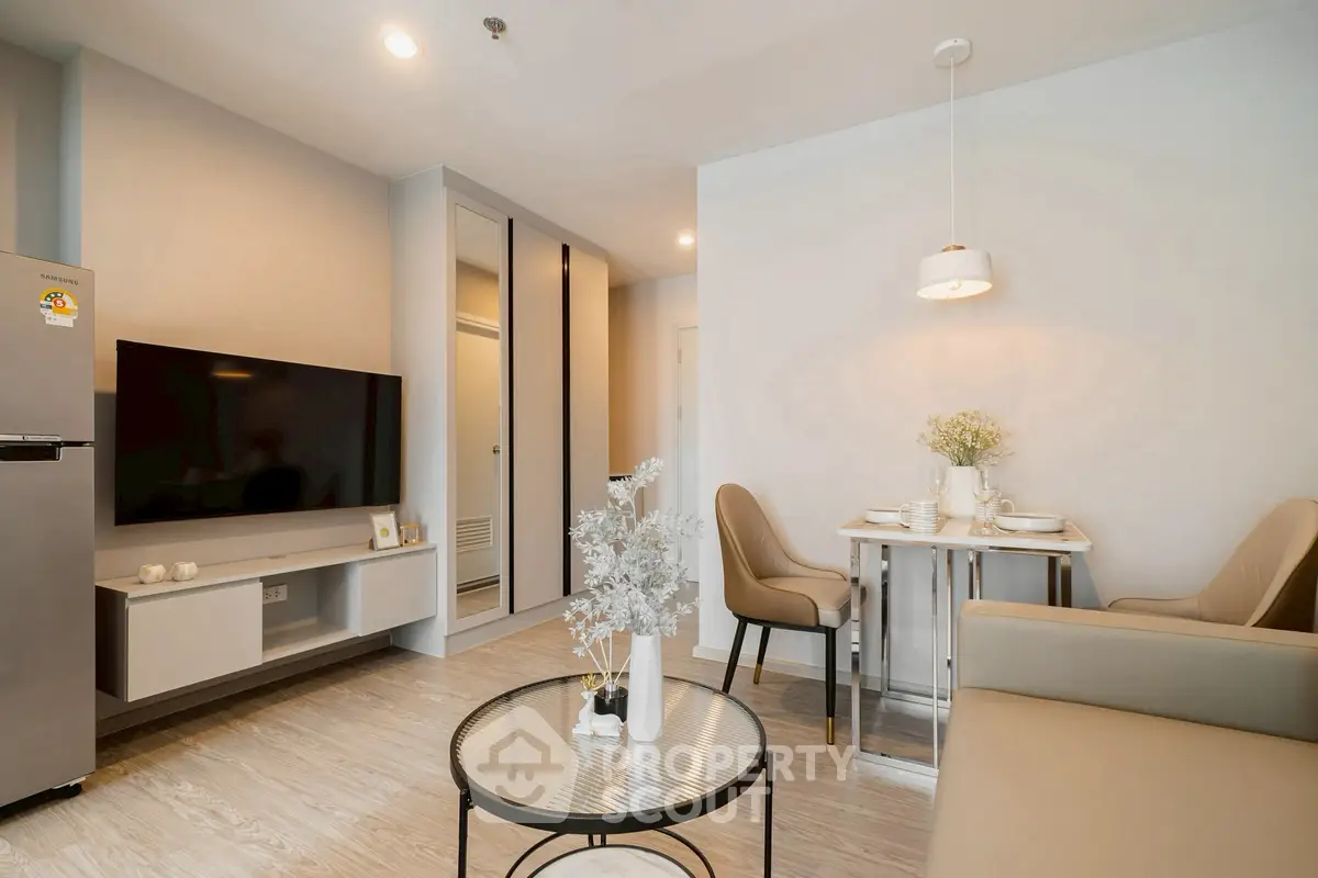 Modern living room with stylish decor and dining area in a cozy apartment.