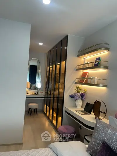 Modern bedroom with stylish decor, built-in wardrobe, and cozy workspace
