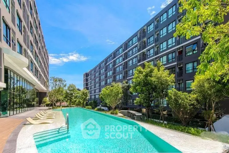 Luxurious modern apartment complex with stunning pool and lush greenery