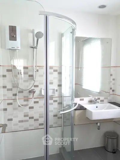 Modern bathroom with glass shower and stylish tile design