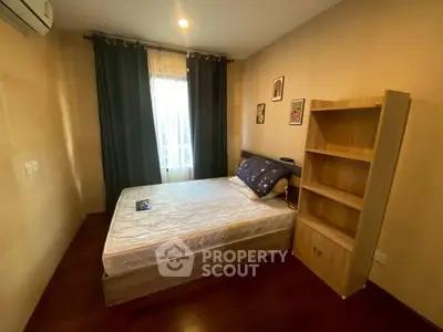 Cozy bedroom with wooden flooring and natural light