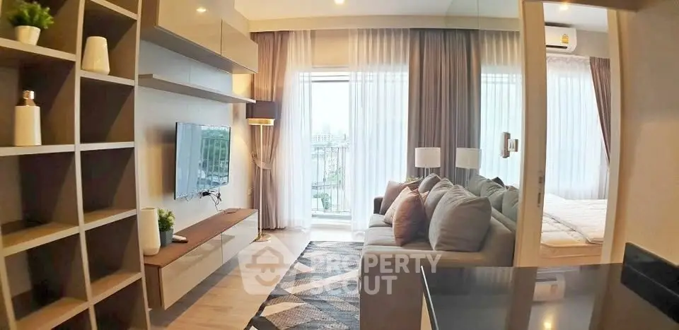 Modern living room with stylish decor and large window offering city view
