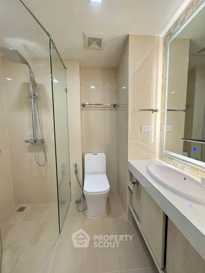 Modern bathroom with glass shower and sleek fixtures