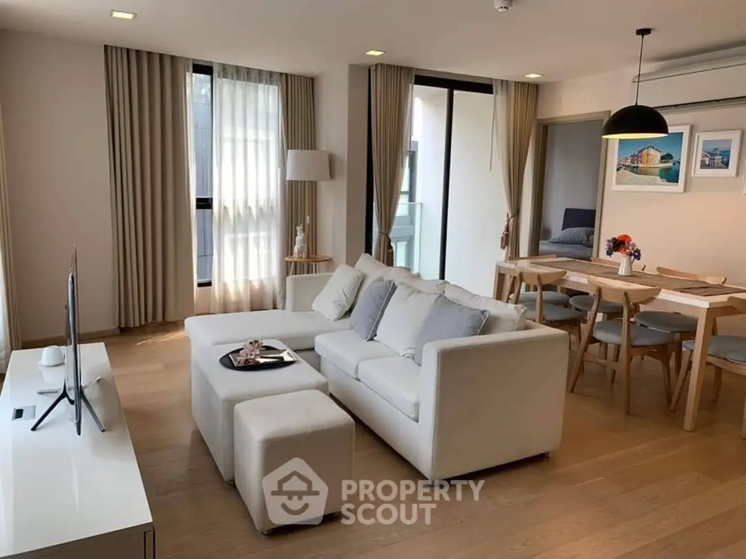 Modern living room with elegant decor, open dining area, and natural light, perfect for stylish urban living.
