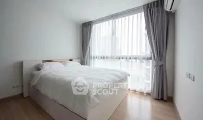 Bright and airy bedroom with large window and modern decor