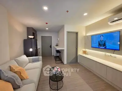 Modern living room with sleek design and wall-mounted TV, featuring cozy seating and stylish decor.