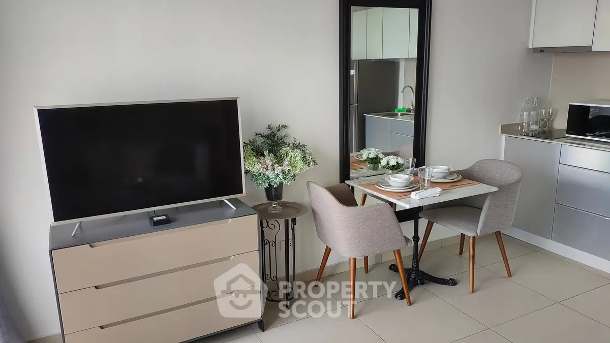 Modern living room with sleek TV setup and cozy dining area