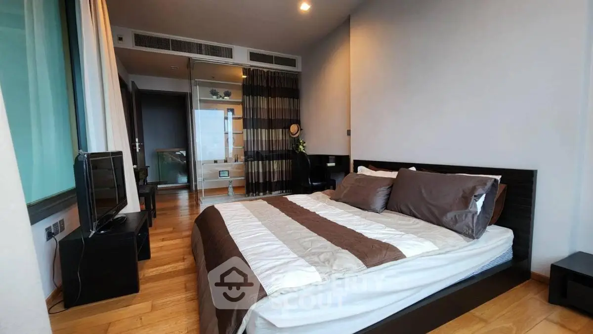 Modern bedroom with stylish decor and wooden flooring