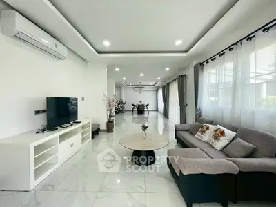 Spacious modern living room with elegant decor and ample natural light