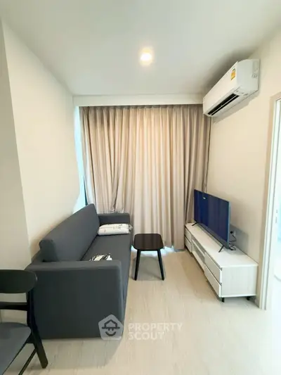 Modern living room with sleek furniture and air conditioning in a cozy apartment.