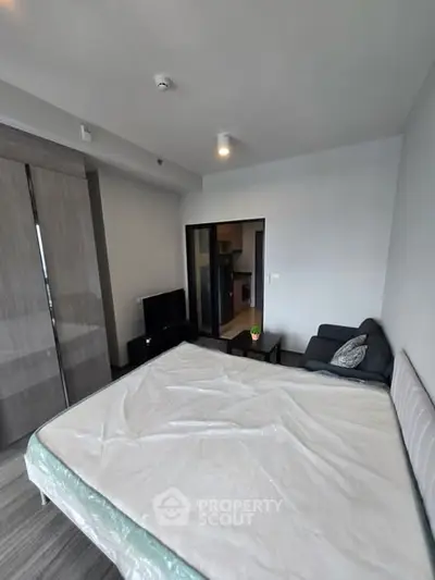 Modern bedroom with sleek furniture and large wardrobe in a contemporary apartment.