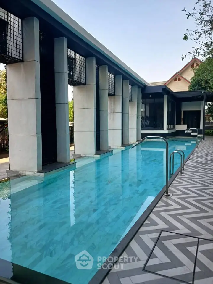 Luxurious modern poolside area with sleek architectural design and serene ambiance.