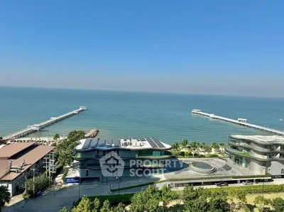 Stunning oceanfront view from high-rise building with modern architecture and lush greenery.