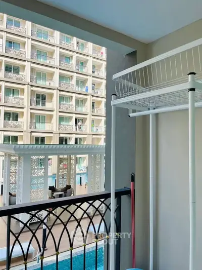 Modern apartment balcony with pool view and stylish railing