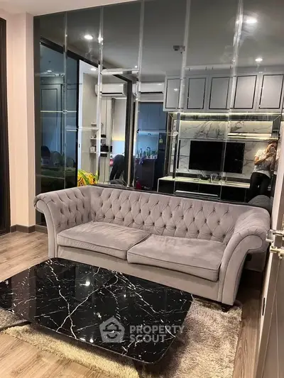 Luxurious modern living room with elegant gray sofa and sleek black marble coffee table.