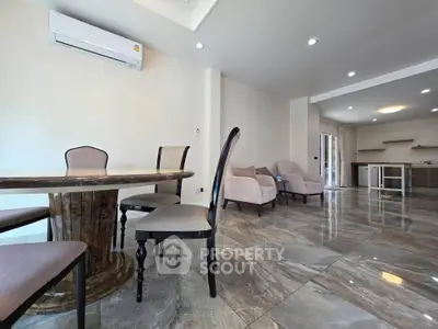 Spacious modern living room with elegant dining area and open kitchen layout