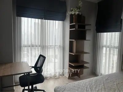 Modern bedroom with large windows, stylish shelving, and a cozy workspace, perfect for urban living.