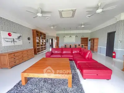 Spacious living room with red sectional sofa and wooden furniture