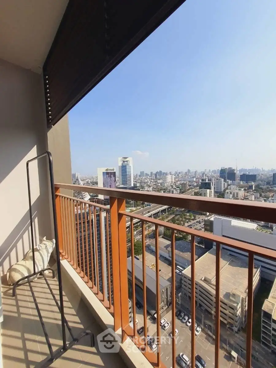 Stunning cityscape view from a high-rise balcony with modern railing.