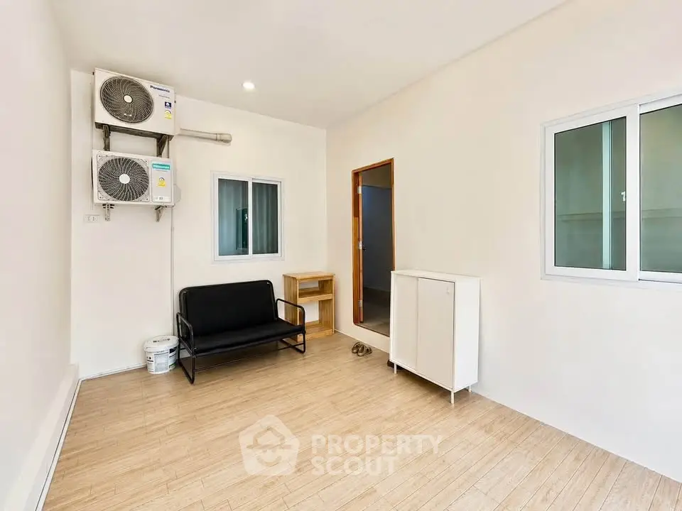 Minimalist room with air conditioning and modern furnishings, perfect for a cozy living space.